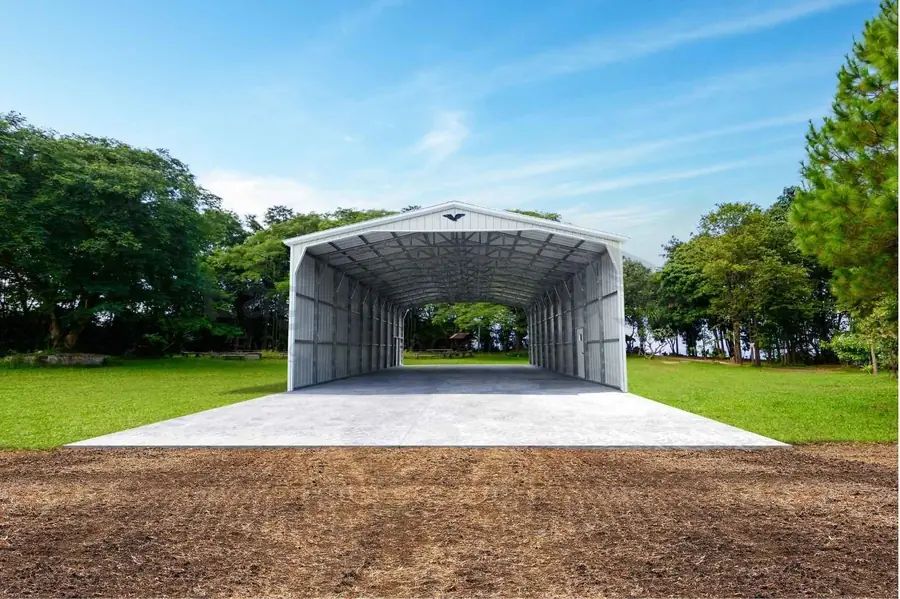 Open white metal carport on a concrete pad