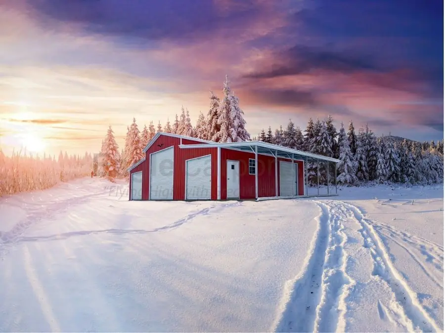 Red metal garage in the snow at sunset