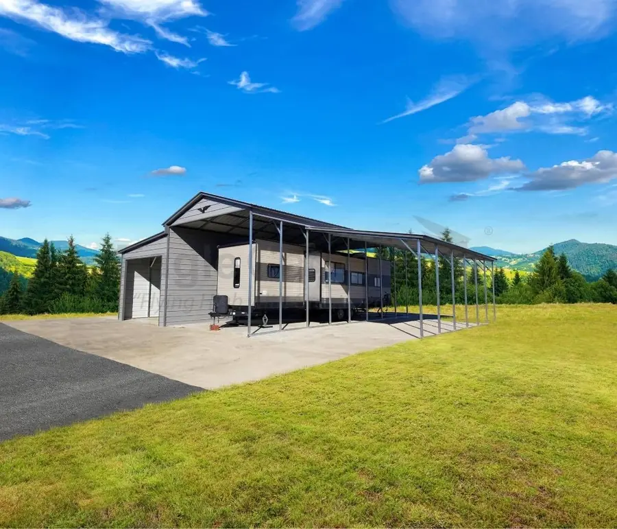 Metal building with lean-to on a hillside